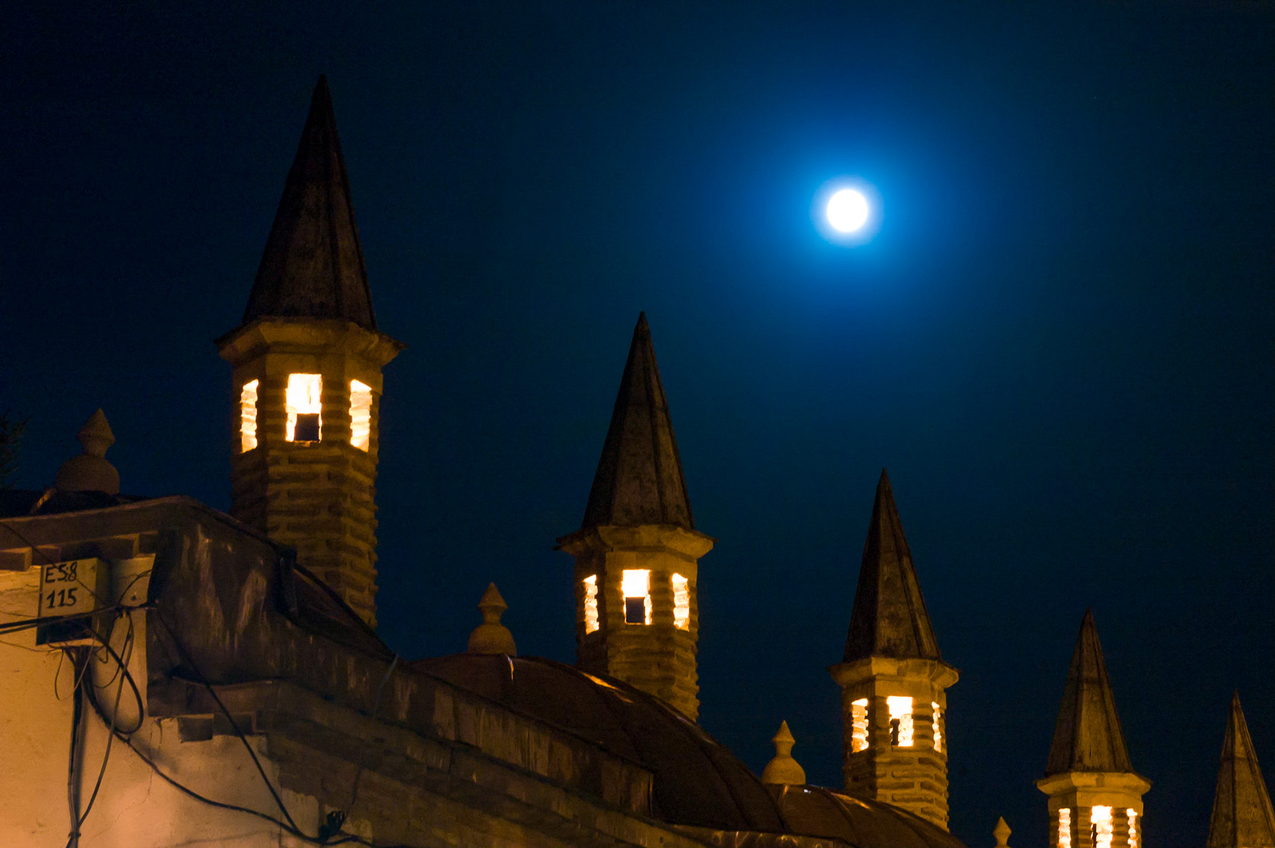 Image of spires of Mevlana Sufi Mosque at night with full moon, Konya, Turkey. 