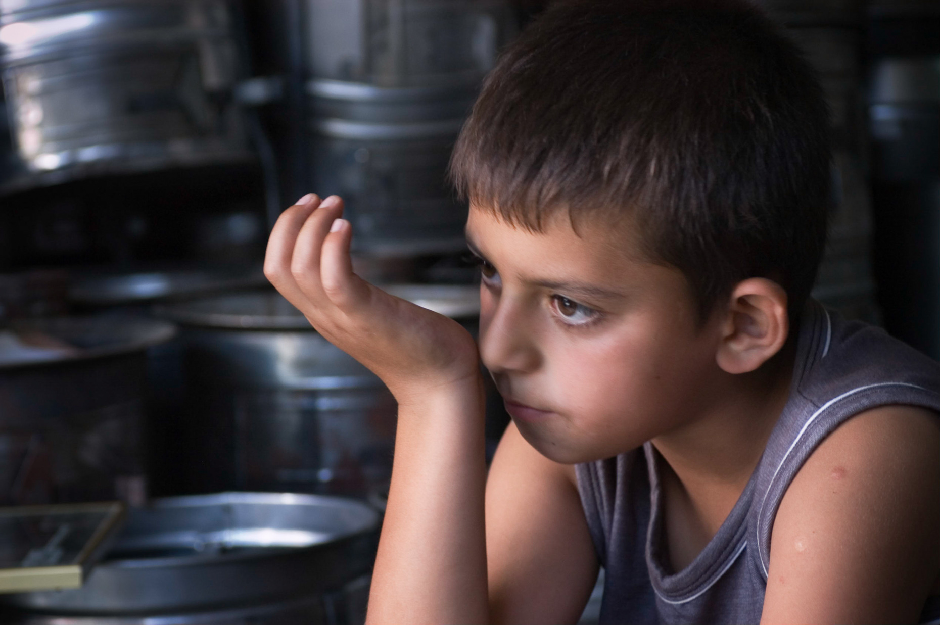 Portrait of young boy, who is the son of the metal worker,   in Grand Bazaar, Konya, Turkey. 