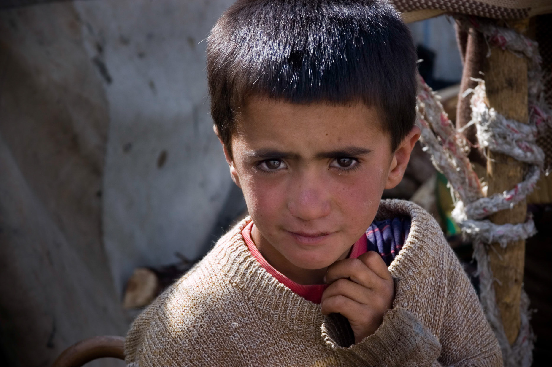 Close up portrait of nomadic Kurdish boy in remote mountain village near Syrian border, Turkey. 