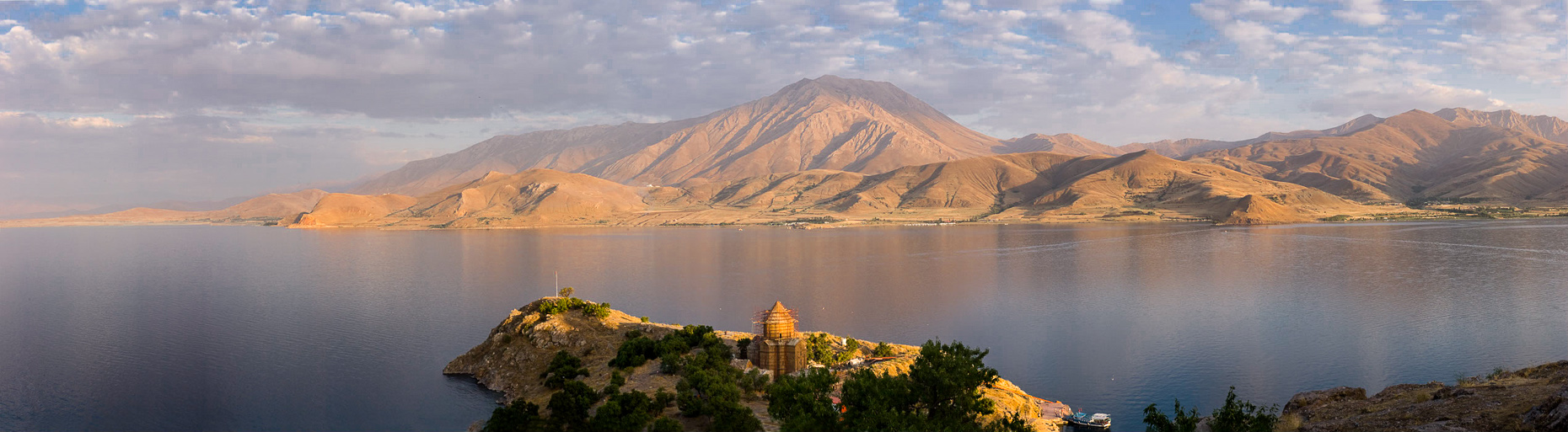 Panoramic landscape of Akdamar Island in middle of Van Lake, Van Turkey, made at sunset. 
