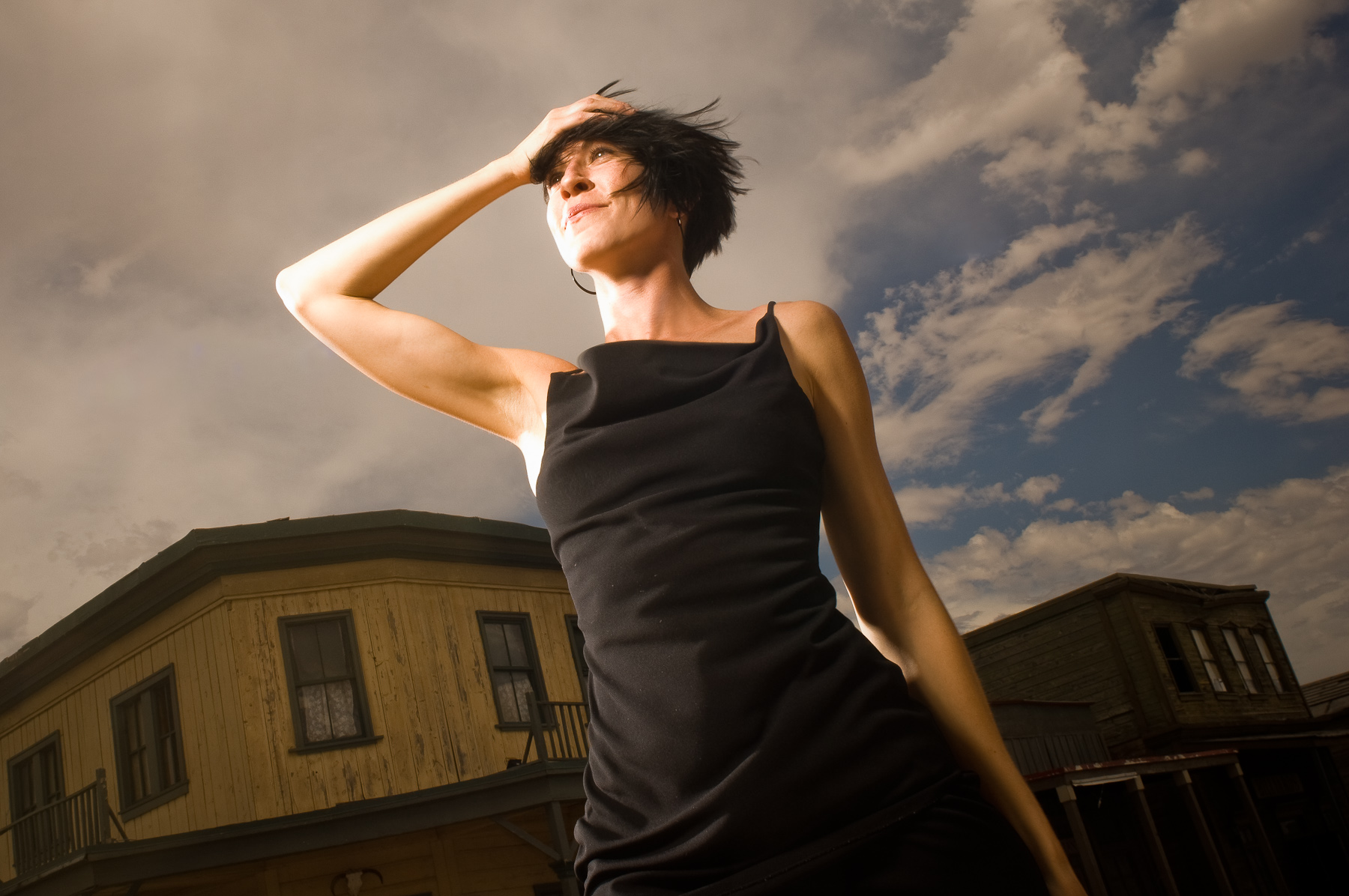 Outdoor fashion portrait of woman in black dress