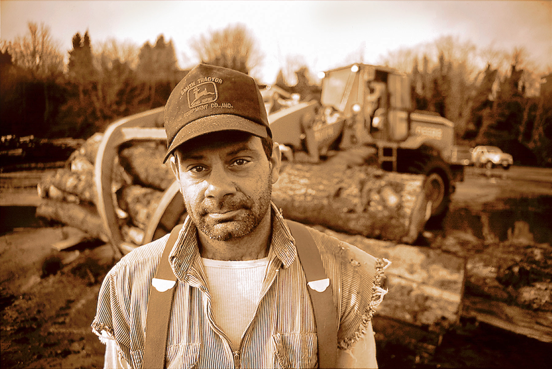 Sepia environmental portrait of a logger guy