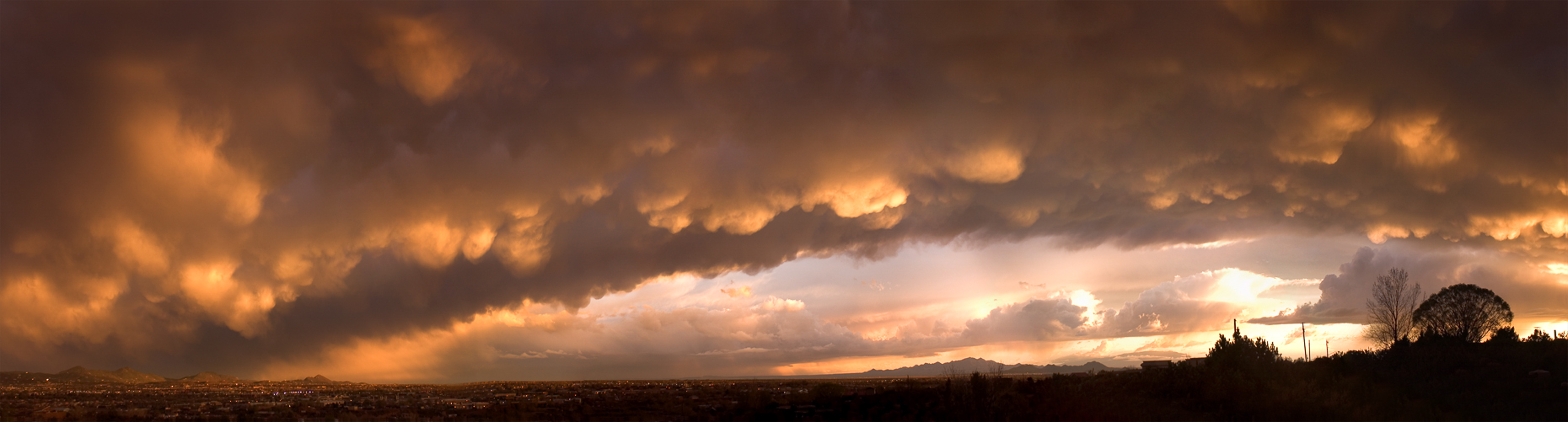 Panoramic of dramatic storm canopy of undelit clouds at sunset, Santa Fe New Mexico.