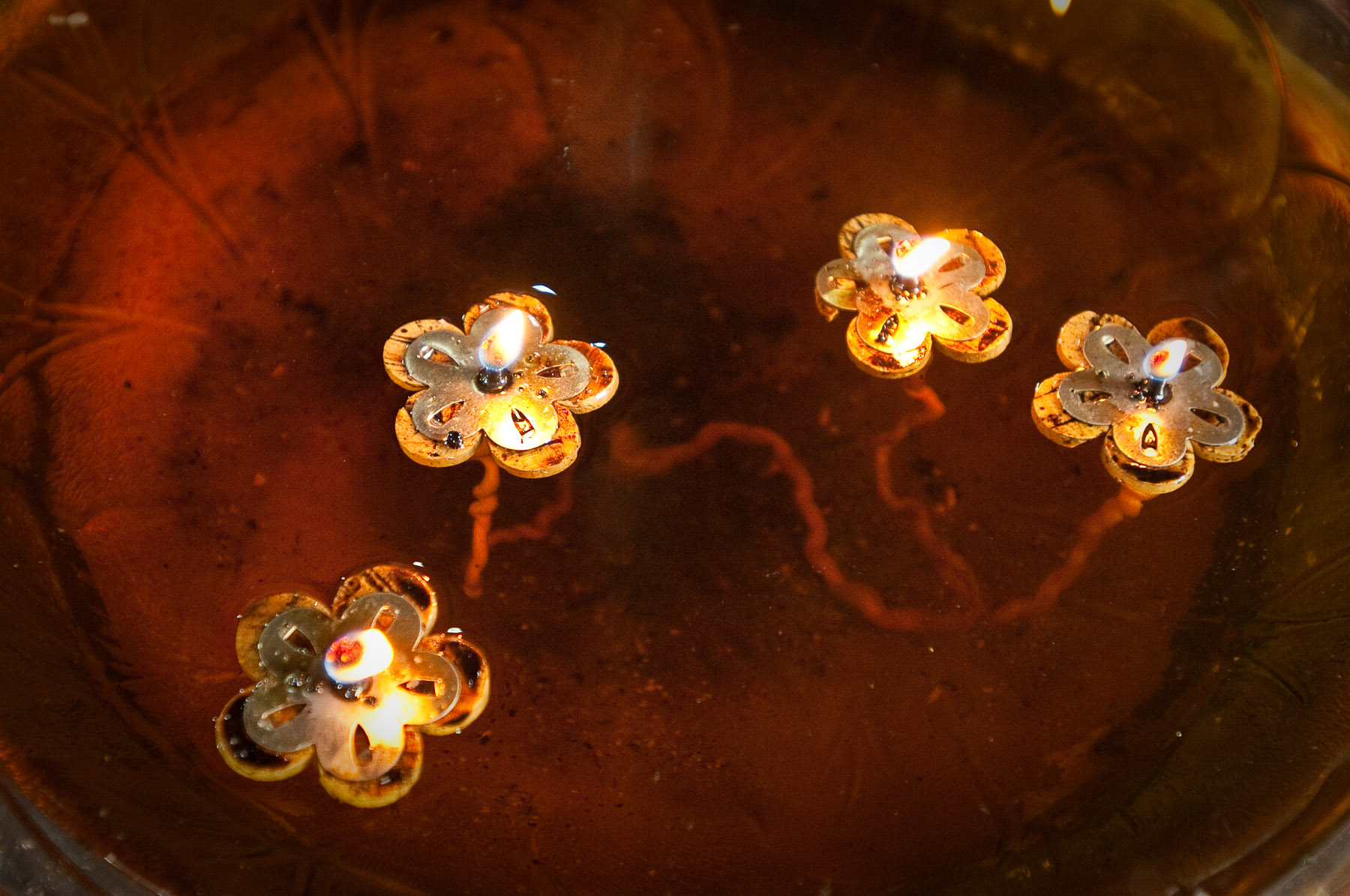 Floating floral candles in Buddhist Temple, Phnom Penh Cambodia.