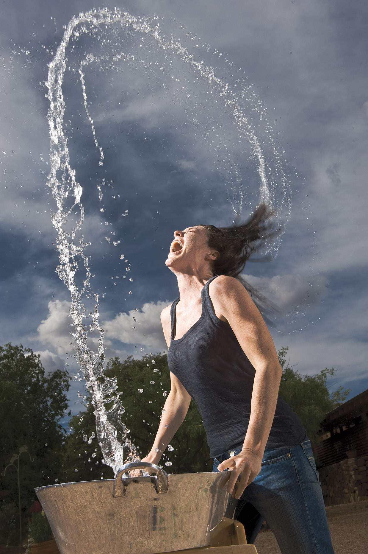 Dramatic portrait of woman throwing wet hair.