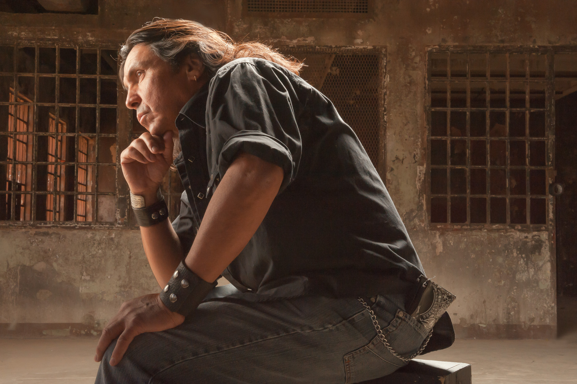 Dramatic edge lit portrait of long hair rock star